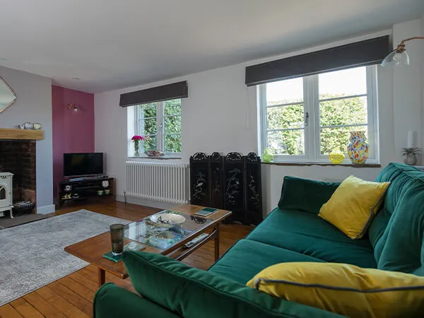A living room with two white UPVC windows