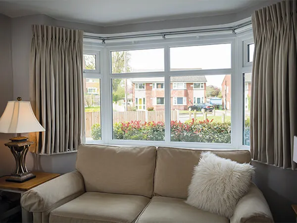 A sofa and white bow window